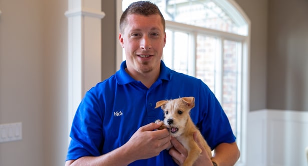 Hoffmann repairman holding cute puppy.