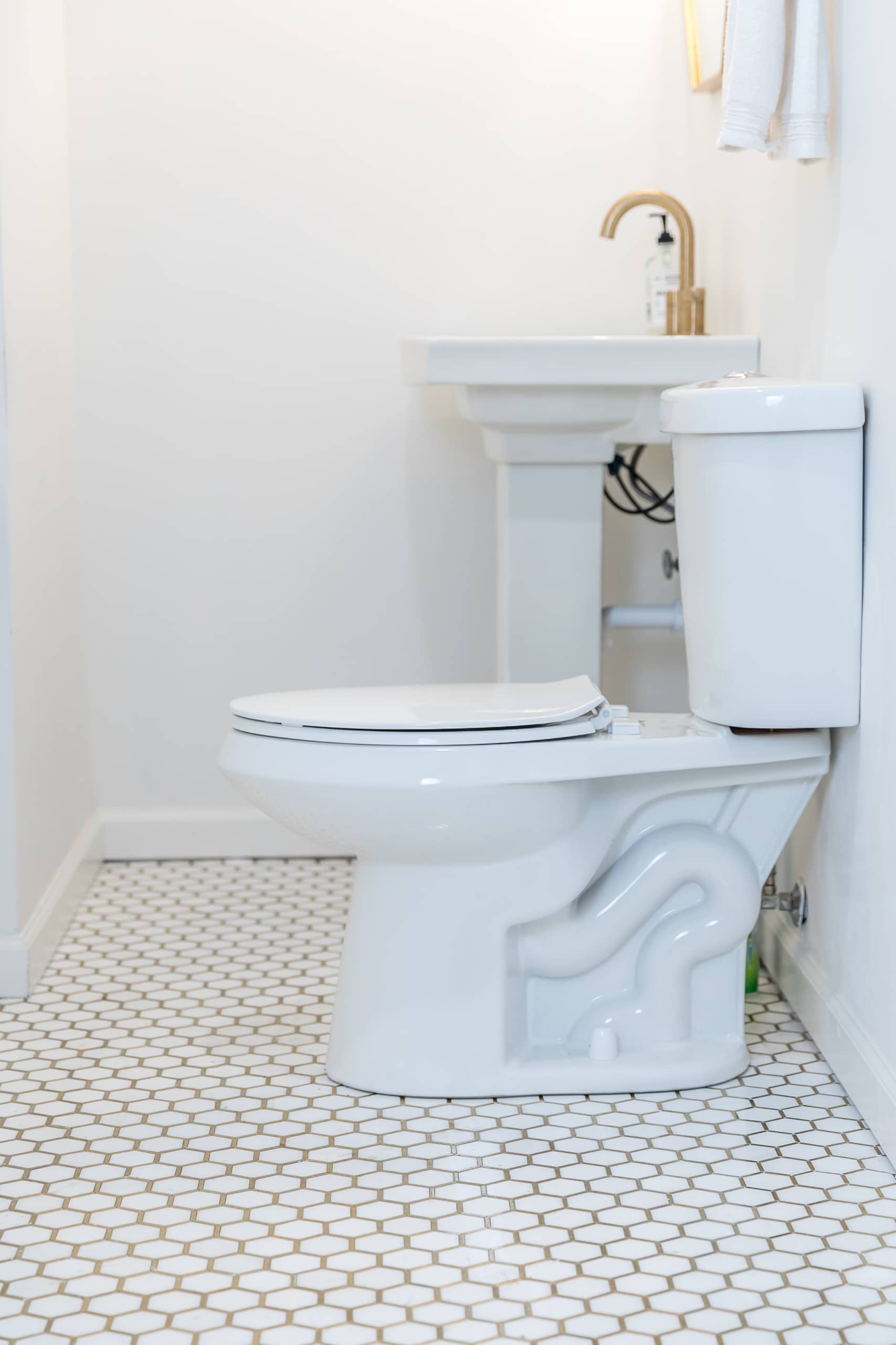 Photo of Residential Toilet from the side with a sink in the background