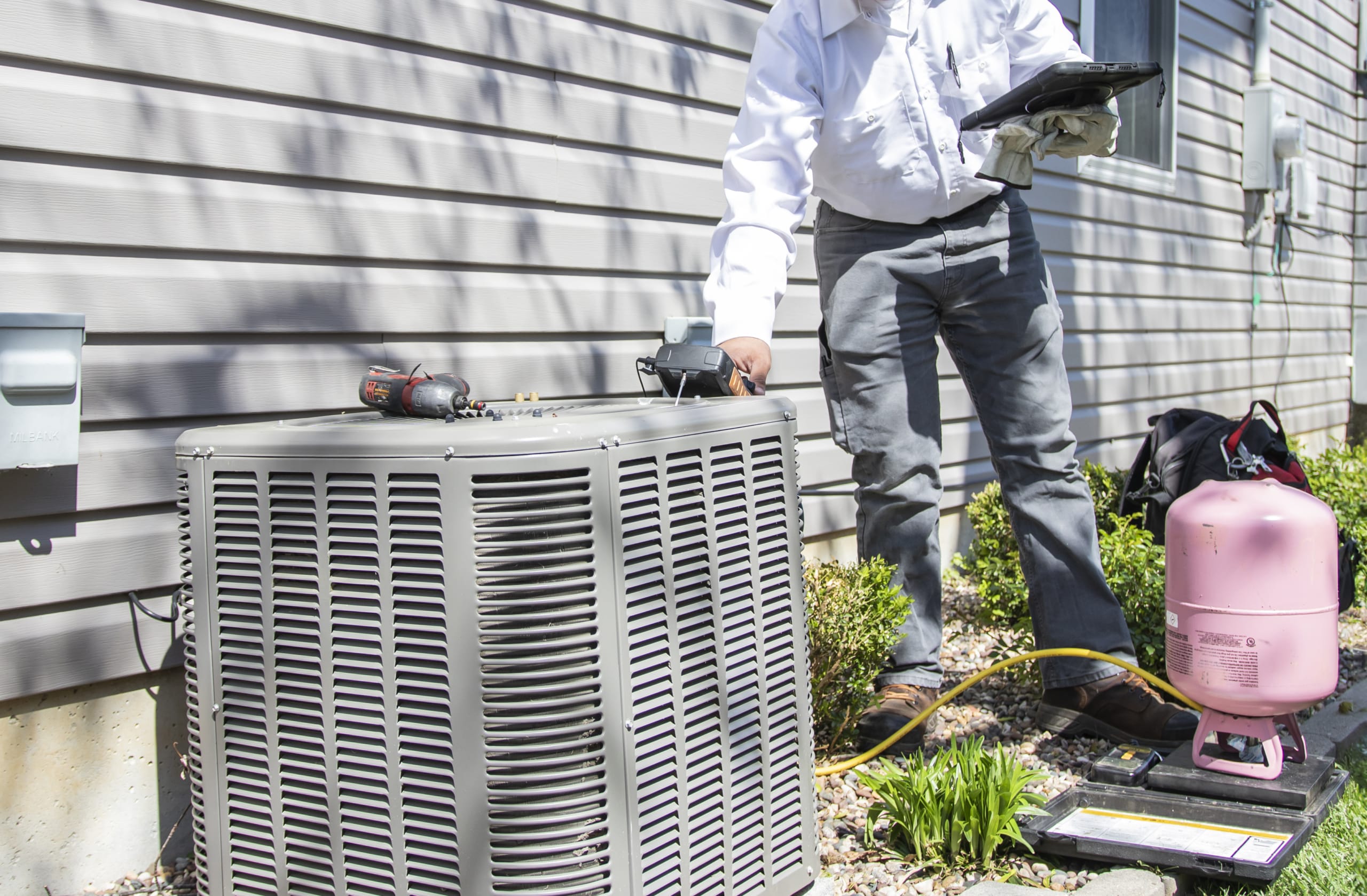 A Homeowner Calling A HVAC Technician For Heating Installation Services