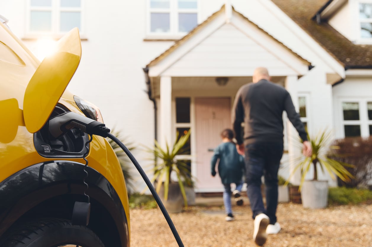 Homeowner Plugging Their Level 2 EV Charger Into Their Electric Car