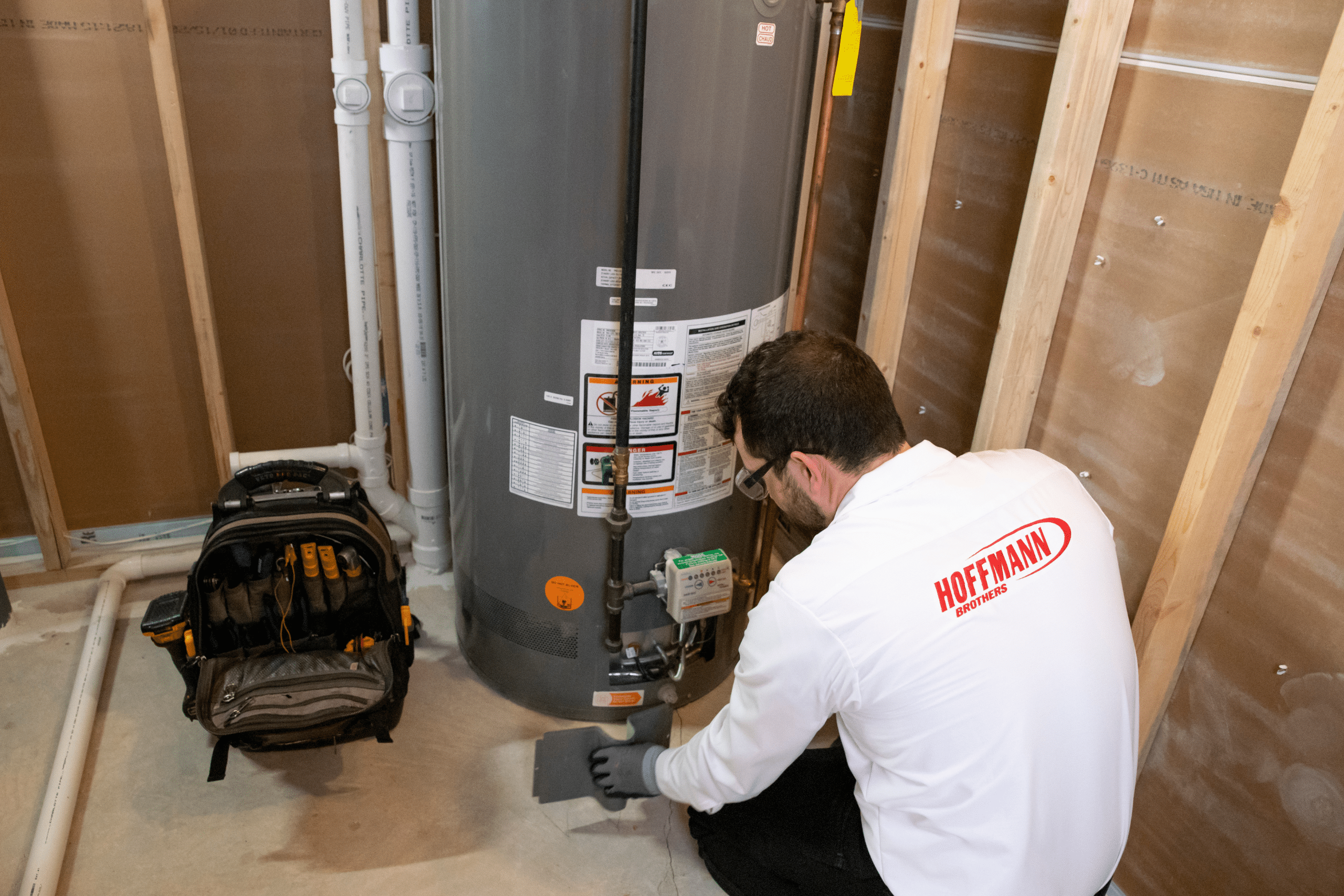 Technician Performing Same Day Water Heater Installation In A Home
