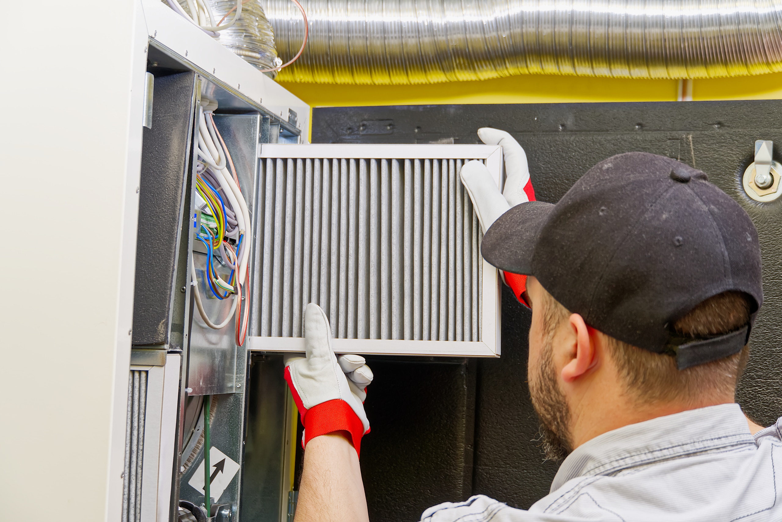 Homeowner regularly maintaining their HVAC to extend system lifespan
