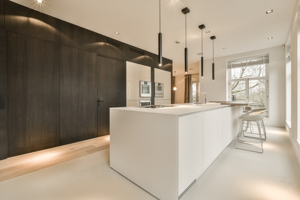 Kitchen with different types of light fixtures like recessed lighting and pendant lights