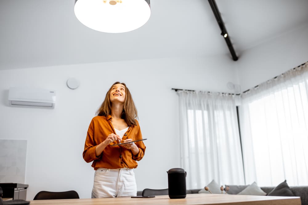 Person controlling their home's lighting with a tablet