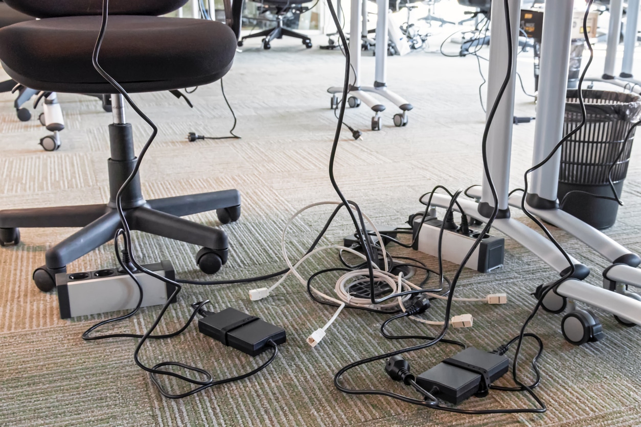 Cable management at a technology center putting business at risk of electrical fire.