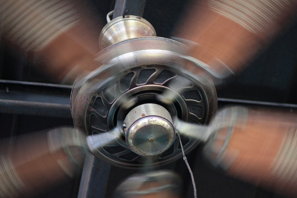 Ceiling fan running to conserve energy while the air conditioner is on